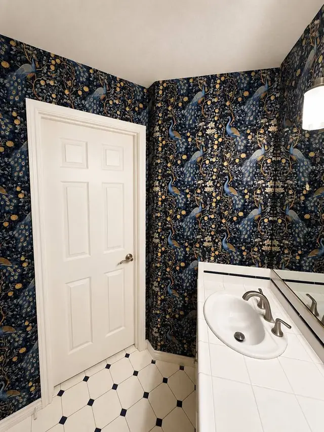 Navy peacock wallpaper in a powder room, Portland