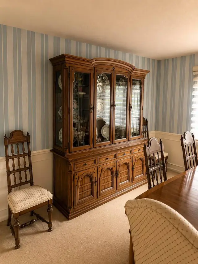 Blue and cream striped wallpaper behind a china cabinet in a dining room, Vancouver