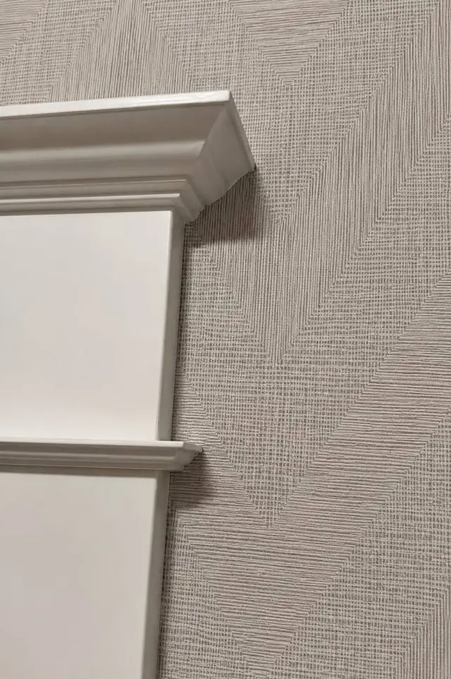 Textured grasscloth wallpaper cut cleanly around white molding, Vancouver