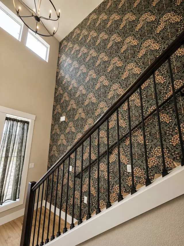 Green and gold William Morris non-woven wallpaper on a stairwell, Vancouver